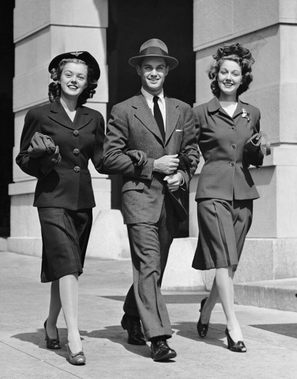 Man & two woman strolling on urban street