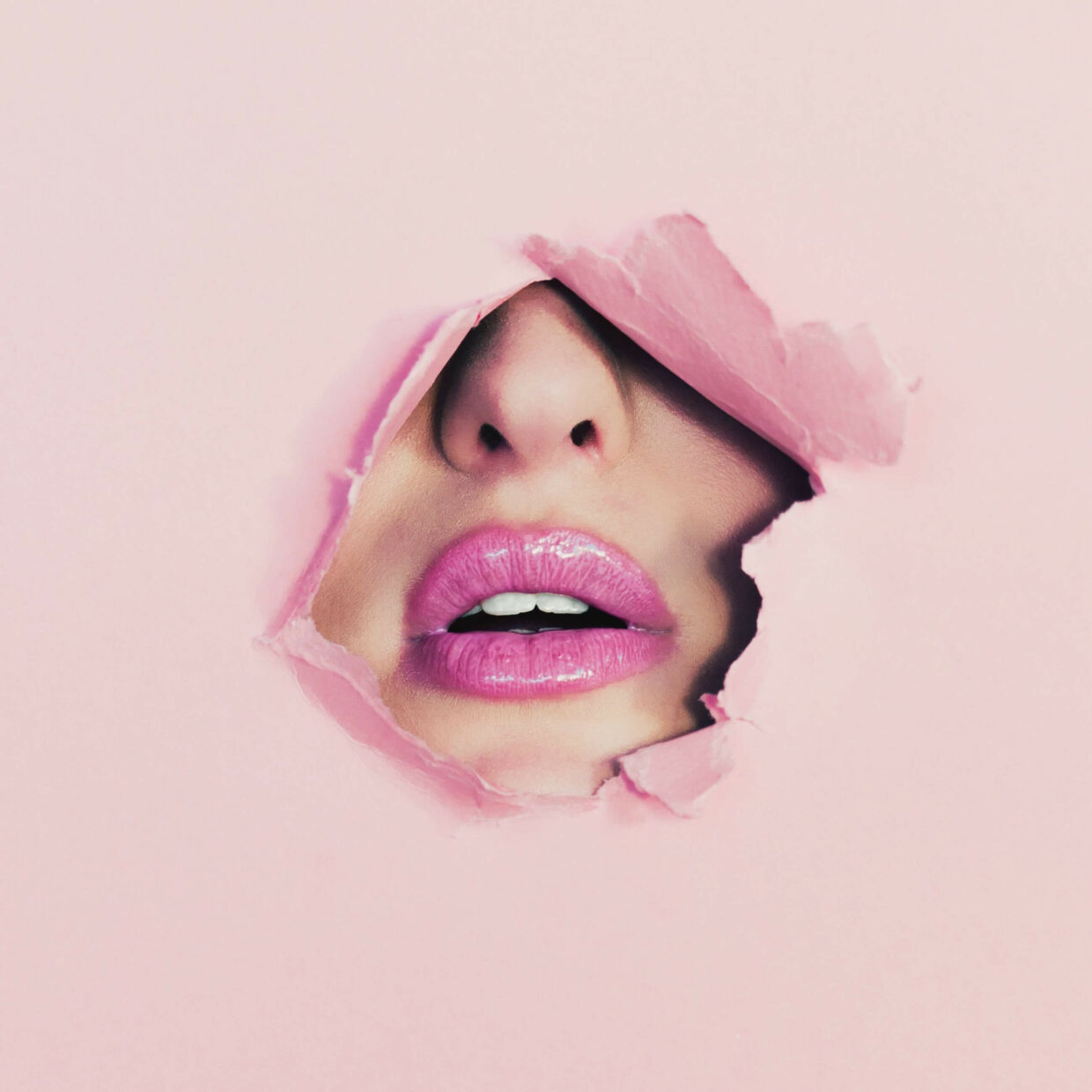 cropped-image-of-female-lips-seen-through-torn-royalty-free-image-15731186a52-scaled